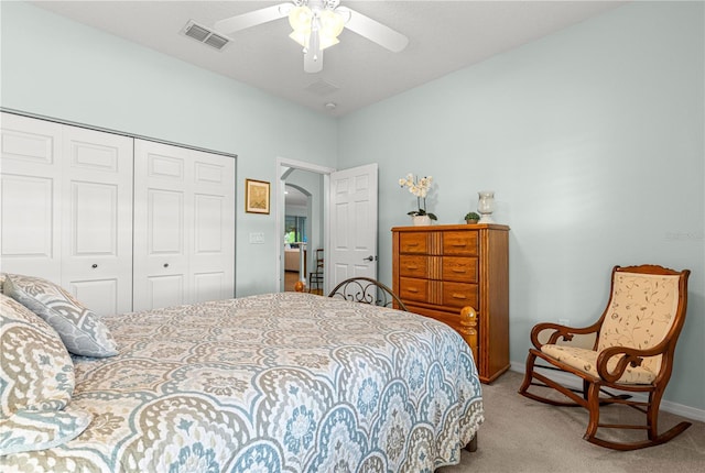 8566 SW 83rd Loop, Ocala, FL 34481 - bedroom with light carpet, a closet, arched walkways, and ceiling fan