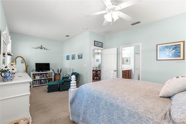 8566 SW 83rd Loop, Ocala, FL 34481 - bedroom with light carpet, a ceiling fan, connected bathroom, and a chandelier