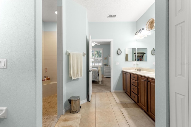 8566 SW 83rd Loop, Ocala, FL 34481 - ensuite bathroom with double vanity, tile patterned flooring, walk in shower, ceiling fan, and a textured ceiling