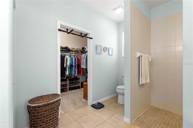 8566 SW 83rd Loop, Ocala, FL 34481 - bathroom featuring tile patterned flooring, tiled shower, and a spacious closet