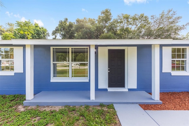 14761 SW 35th Terrace Rd, Ocala, FL 34473 - view of exterior entry with a porch and concrete block siding