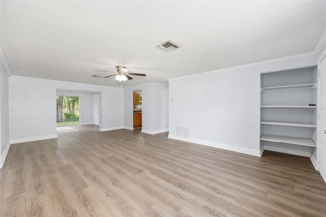 14761 SW 35th Terrace Rd, Ocala, FL 34473 - unfurnished living room with a ceiling fan, wood finished floors, ornamental molding, and built in shelves