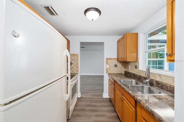 14761 SW 35th Terrace Rd, Ocala, FL 34473 - kitchen featuring refrigerator, wood finished floors, tasteful backsplash, brown cabinets, and dark countertops