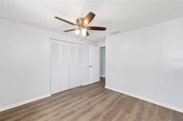 14761 SW 35th Terrace Rd, Ocala, FL 34473 - unfurnished bedroom with wood finished floors, a closet, and a ceiling fan