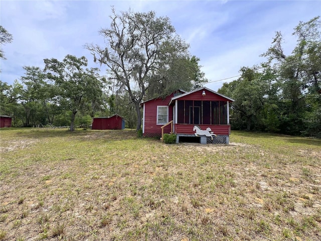 23161 NE 155th Ct, Fort Mc Coy, FL 32134 - view of grassy yard with a sunroom and a shed