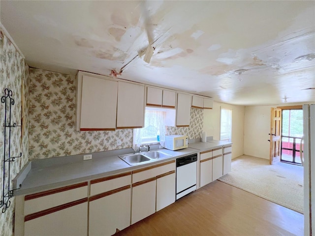 23161 NE 155th Ct, Fort Mc Coy, FL 32134 - kitchen featuring white appliances, wallpapered walls, light wood finished floors, light countertops, and white cabinets