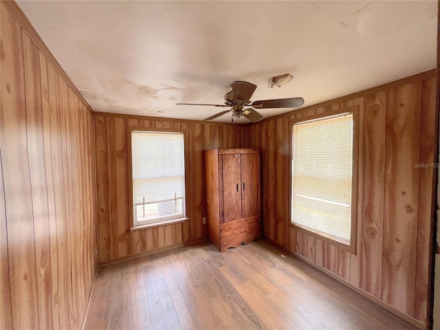 23161 NE 155th Ct, Fort Mc Coy, FL 32134 - empty room featuring light wood-type flooring, wood walls, and ceiling fan