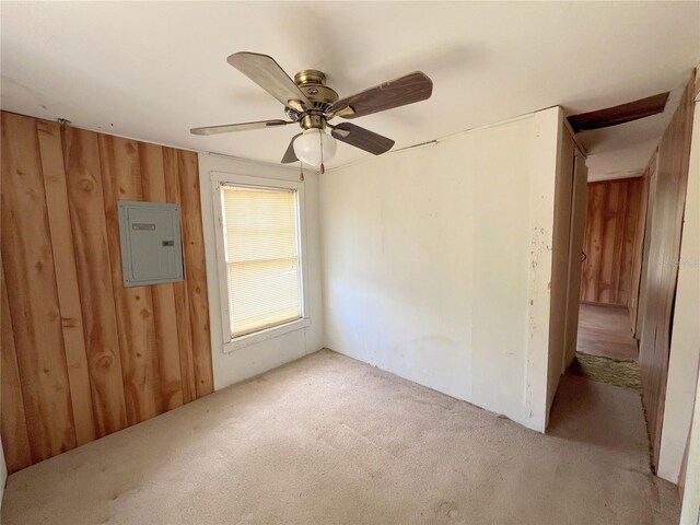 23161 NE 155th Ct, Fort Mc Coy, FL 32134 - empty room featuring electric panel, carpet, ceiling fan, and wood walls