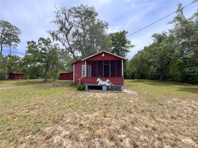 23161 NE 155th Ct, Fort Mc Coy, FL 32134 - view of grassy yard with a sunroom
