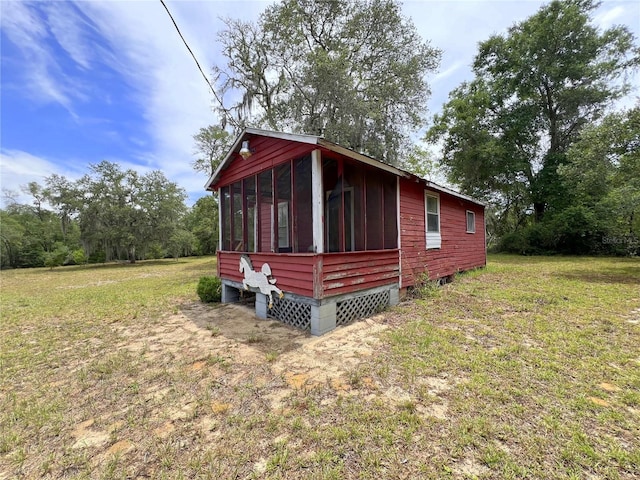 23161 NE 155th Ct, Fort Mc Coy, FL 32134 - view of property exterior featuring a sunroom and a lawn