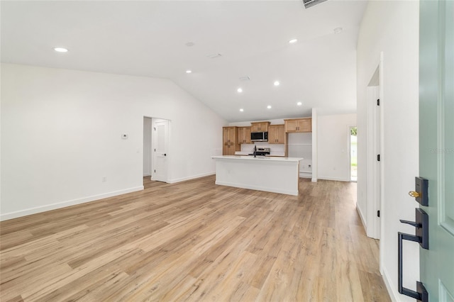 5400 NW 9th St, Ocala, FL 34482 - unfurnished living room with lofted ceiling, recessed lighting, and light wood-style flooring