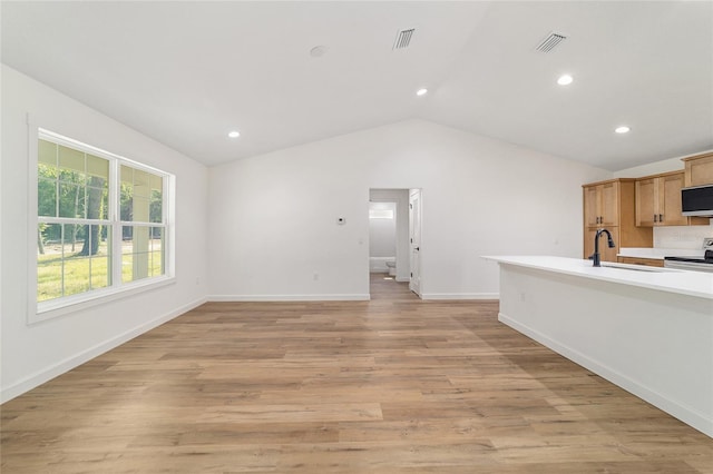 5400 NW 9th St, Ocala, FL 34482 - unfurnished living room featuring vaulted ceiling, recessed lighting, and light wood-style floors
