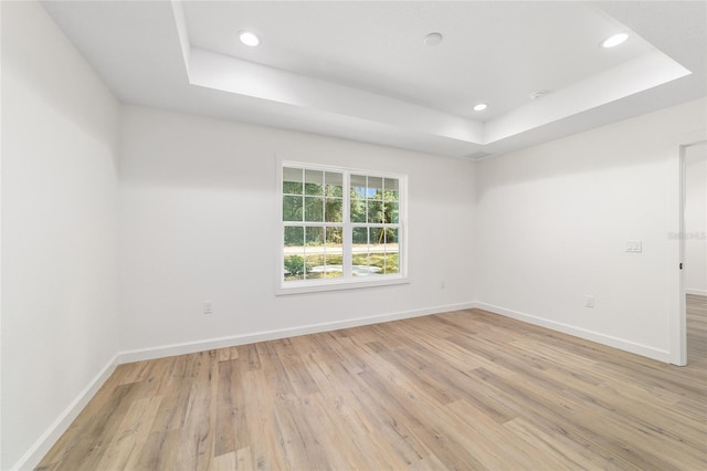 5400 NW 9th St, Ocala, FL 34482 - empty room featuring a raised ceiling, light wood finished floors, and recessed lighting