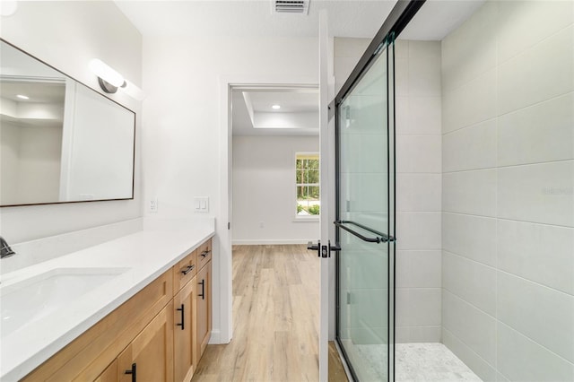5400 NW 9th St, Ocala, FL 34482 - full bathroom with vanity, wood finished floors, a tile shower, and recessed lighting