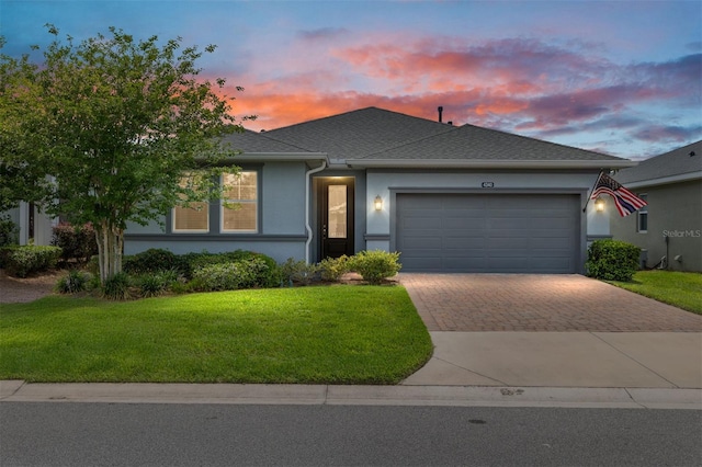 4340 NW 56th Ct, Ocala, FL 34482 - view of front of house with decorative driveway, a garage, a yard, and stucco siding