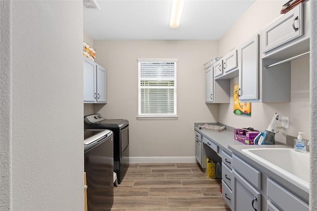 4340 NW 56th Ct, Ocala, FL 34482 - laundry area with independent washer and dryer, wood tiled floors, and cabinet space