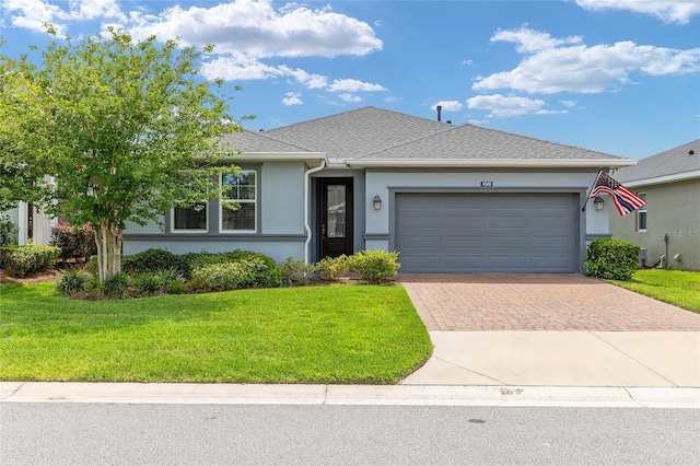 4340 NW 56th Ct, Ocala, FL 34482 - ranch-style home featuring decorative driveway, an attached garage, stucco siding, and a front lawn