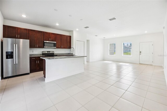 15212 SW 27th Ct, Ocala, FL 34473 - kitchen featuring appliances with stainless steel finishes, recessed lighting, light tile patterned flooring, light stone counters, and open floor plan
