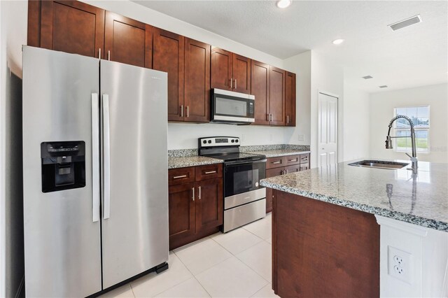 15212 SW 27th Ct, Ocala, FL 34473 - kitchen with appliances with stainless steel finishes, light stone countertops, light tile patterned floors, and recessed lighting