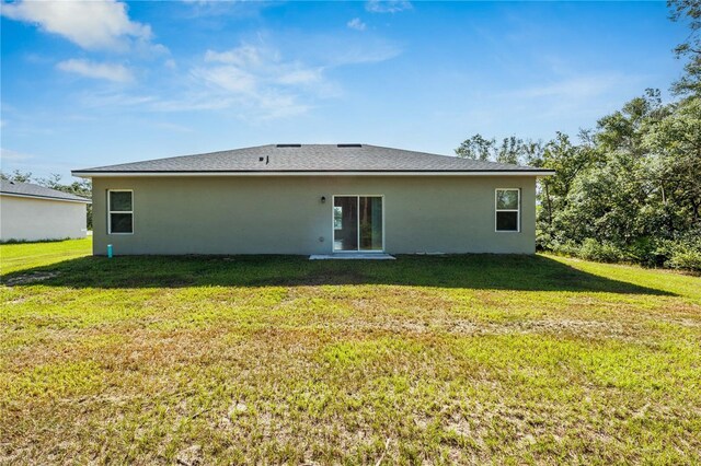 15212 SW 27th Ct, Ocala, FL 34473 - rear view of house featuring a yard and stucco siding