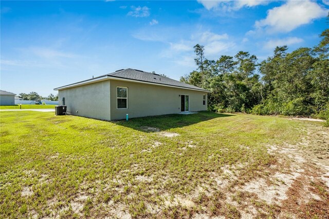 15212 SW 27th Ct, Ocala, FL 34473 - view of side of property with stucco siding and a lawn