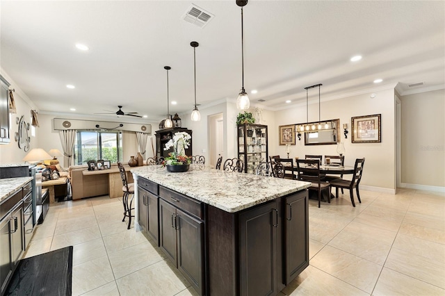 9634 SW 67th St, Ocala, FL 34481 - kitchen with recessed lighting, a ceiling fan, ornamental molding, open floor plan, and a breakfast bar