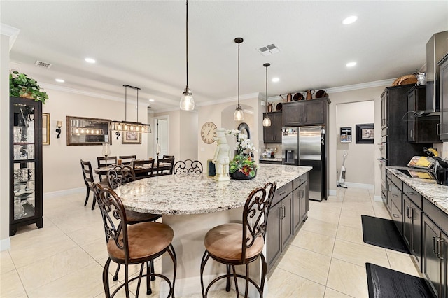 9634 SW 67th St, Ocala, FL 34481 - kitchen featuring appliances with stainless steel finishes, a breakfast bar, a center island, light stone counters, and recessed lighting