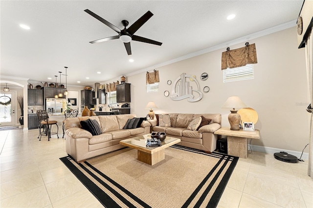 9634 SW 67th St, Ocala, FL 34481 - living room with crown molding, ceiling fan, recessed lighting, arched walkways, and light tile patterned flooring