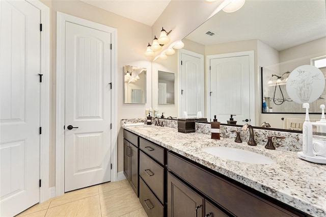 9634 SW 67th St, Ocala, FL 34481 - bathroom with double vanity, tile patterned flooring, and a shower
