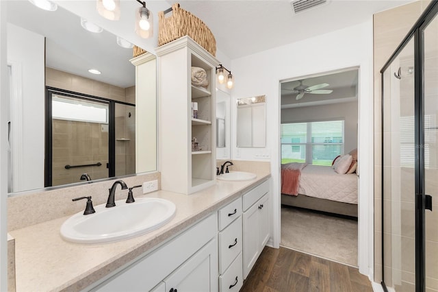 4416 Homan Loop, The Villages, FL 32163 - ensuite bathroom featuring double vanity, healthy amount of natural light, a ceiling fan, and wood finished floors