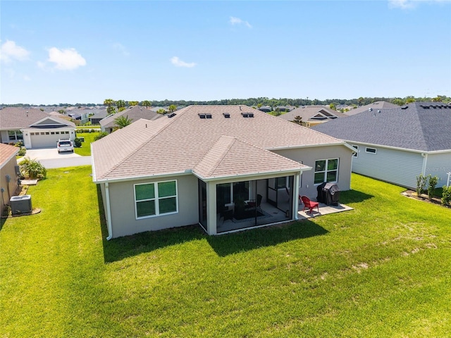 4416 Homan Loop, The Villages, FL 32163 - rear view of property featuring stucco siding, a yard, roof with shingles, and a sunroom