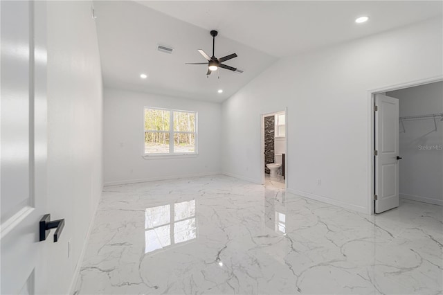 13741 SW 81st Cir, Ocala, FL 34473 - unfurnished bedroom featuring a walk in closet, recessed lighting, light marble finish floors, vaulted ceiling, and ensuite bath