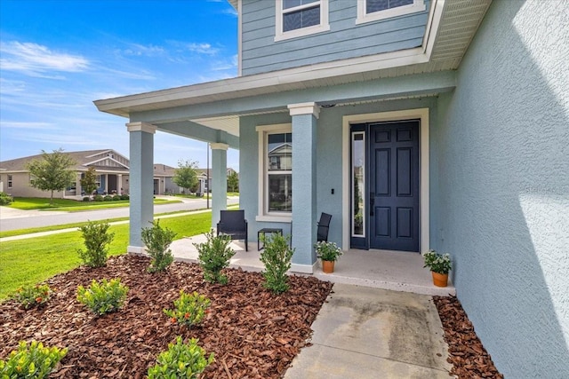 7695 SW 64th Street Rd, Ocala, FL 34474 - doorway to property featuring a porch and stucco siding