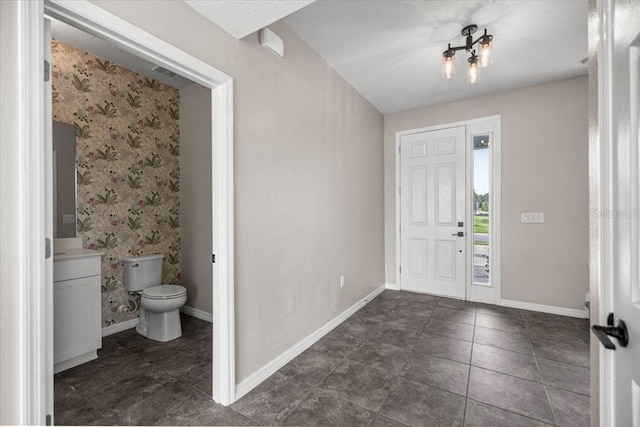 7695 SW 64th Street Rd, Ocala, FL 34474 - foyer entrance featuring a chandelier and wallpapered walls