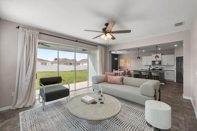 7695 SW 64th Street Rd, Ocala, FL 34474 - living area with ceiling fan and baseboards