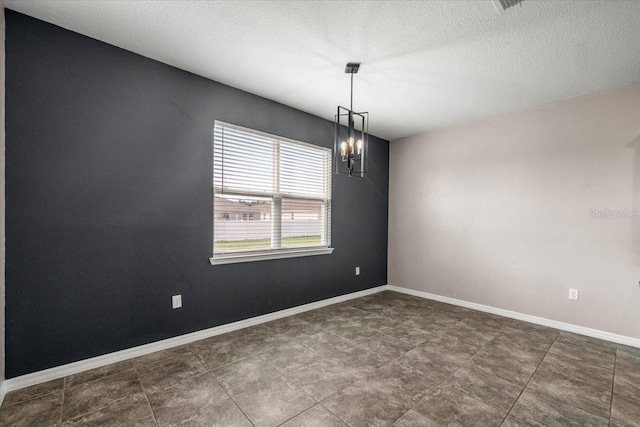 7695 SW 64th Street Rd, Ocala, FL 34474 - empty room featuring a chandelier and a textured ceiling