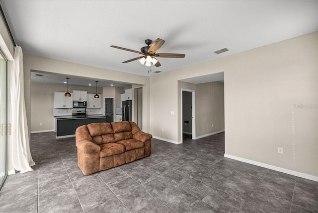 7695 SW 64th Street Rd, Ocala, FL 34474 - living room featuring ceiling fan and baseboards