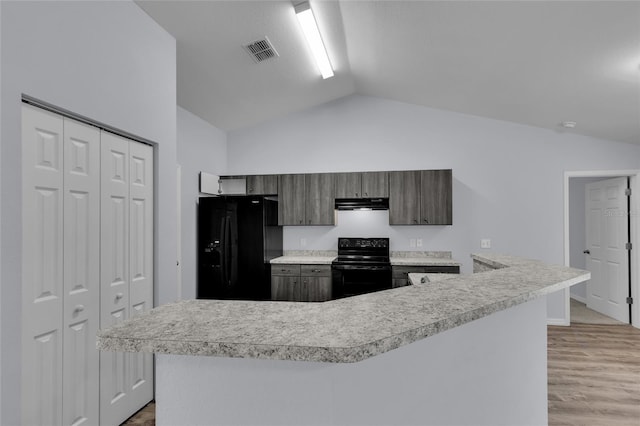 4501 SW 159th Street Rd, Ocala, FL 34473 - kitchen featuring black appliances, under cabinet range hood, light countertops, lofted ceiling, and light wood-style flooring