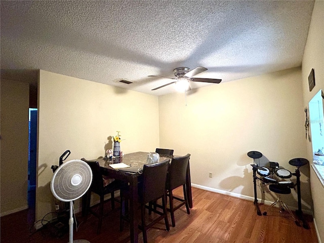 3525 E Fort King St Unit 140, Ocala, FL 34470 - dining room with wood finished floors, a ceiling fan, and a textured ceiling