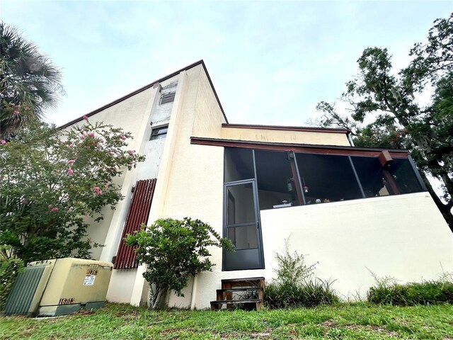 3525 E Fort King St Unit 140, Ocala, FL 34470 - view of home's exterior with a sunroom and stucco siding