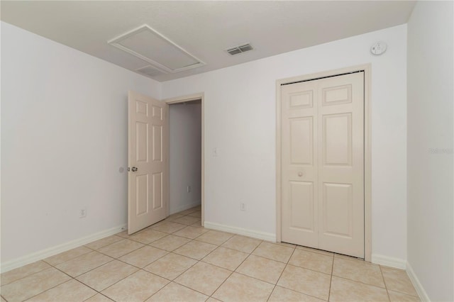 15711 SW 52nd Avenue Rd, Ocala, FL 34473 - unfurnished bedroom with light tile patterned floors, attic access, and a closet