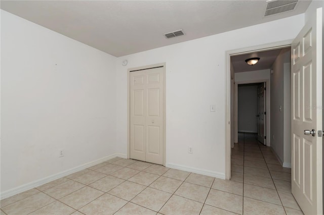 15711 SW 52nd Avenue Rd, Ocala, FL 34473 - unfurnished bedroom with light tile patterned floors and a closet