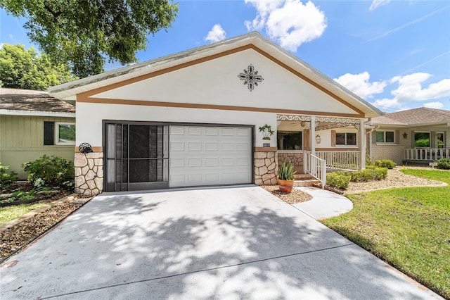 8881 SW 94th St Unit E, Ocala, FL 34481 - view of front of property with an attached garage, stone siding, a porch, driveway, and stucco siding