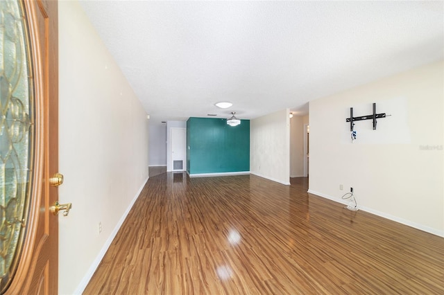8881 SW 94th St Unit E, Ocala, FL 34481 - spare room featuring wood finished floors and a textured ceiling