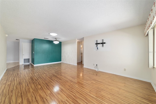 8881 SW 94th St Unit E, Ocala, FL 34481 - unfurnished room featuring a textured ceiling and light wood-style floors