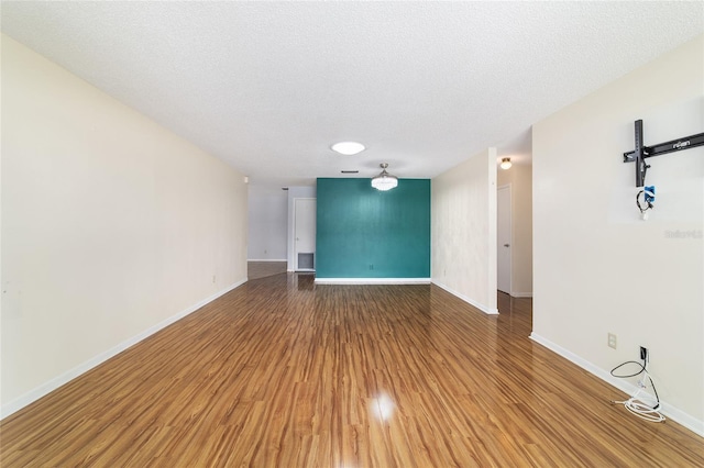 8881 SW 94th St Unit E, Ocala, FL 34481 - spare room featuring light wood-style flooring and a textured ceiling