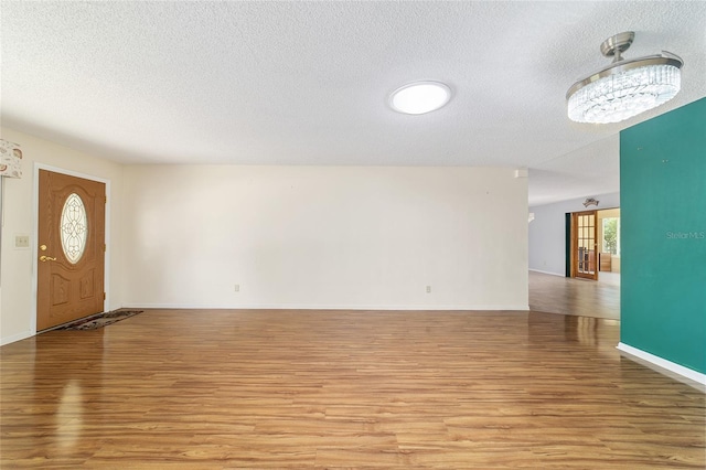 8881 SW 94th St Unit E, Ocala, FL 34481 - entrance foyer featuring light wood-type flooring and a textured ceiling