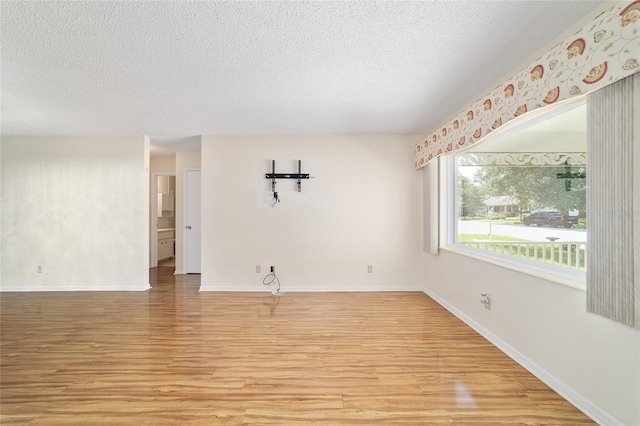 8881 SW 94th St Unit E, Ocala, FL 34481 - unfurnished room featuring light wood finished floors and a textured ceiling