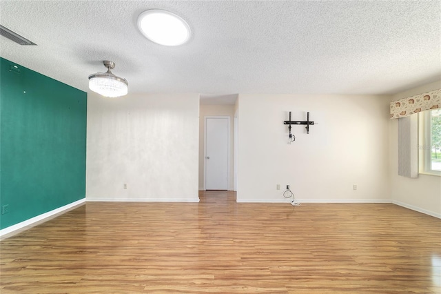 8881 SW 94th St Unit E, Ocala, FL 34481 - spare room featuring a textured ceiling and light wood finished floors