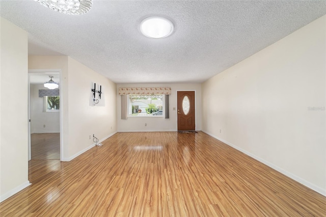 8881 SW 94th St Unit E, Ocala, FL 34481 - foyer entrance featuring light wood-style flooring and a textured ceiling
